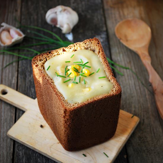 Potato cream soup in bread bowl