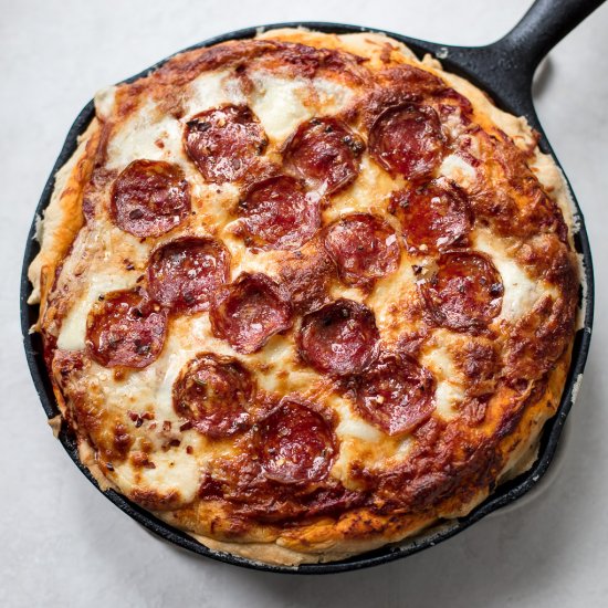 Deep dish pizza with spicy salami