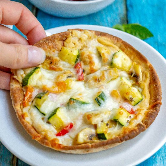 Hummus and veggie pita pizzas