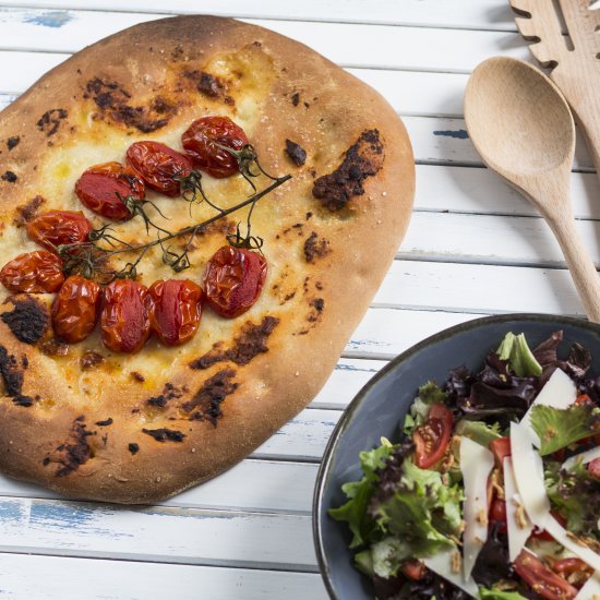 Schiacciata with pesto and tomatoes