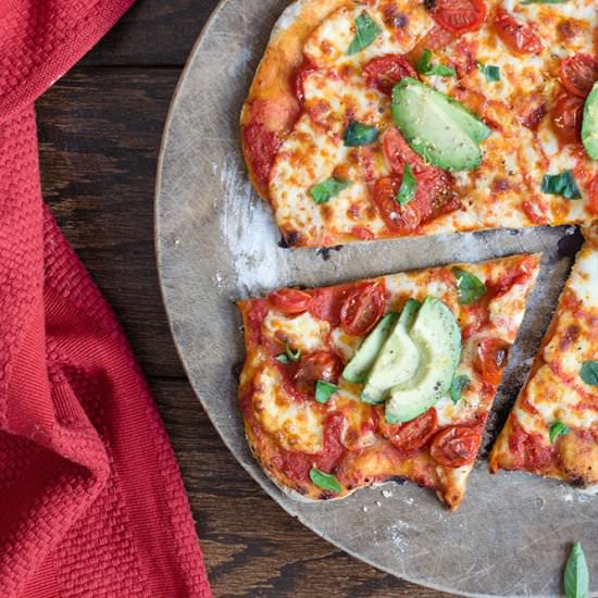 Avocado cherry tomato pizza