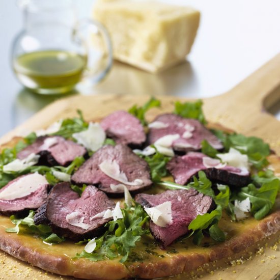 Beef, arugula, and parmesan pizza