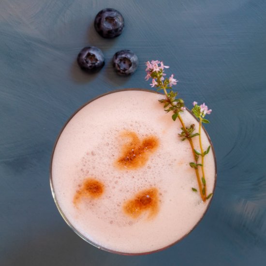 Blueberry pickle pisco sour cocktail