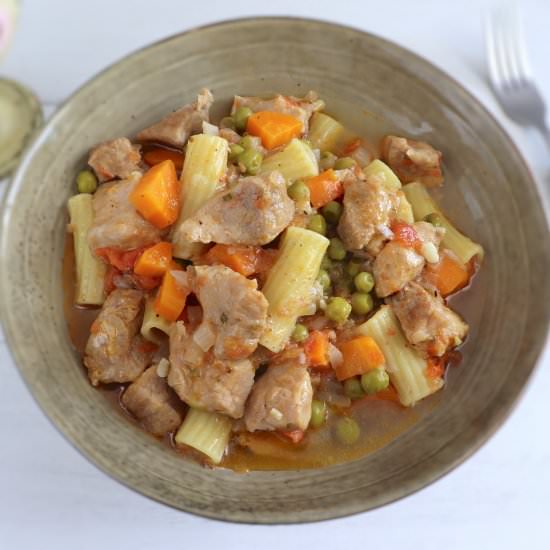 Pork stew with peas, carrot pasta