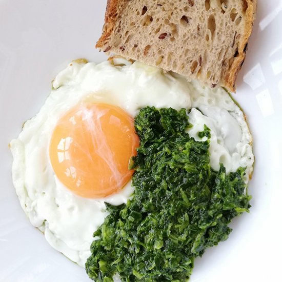 Fried egg with light green pesto